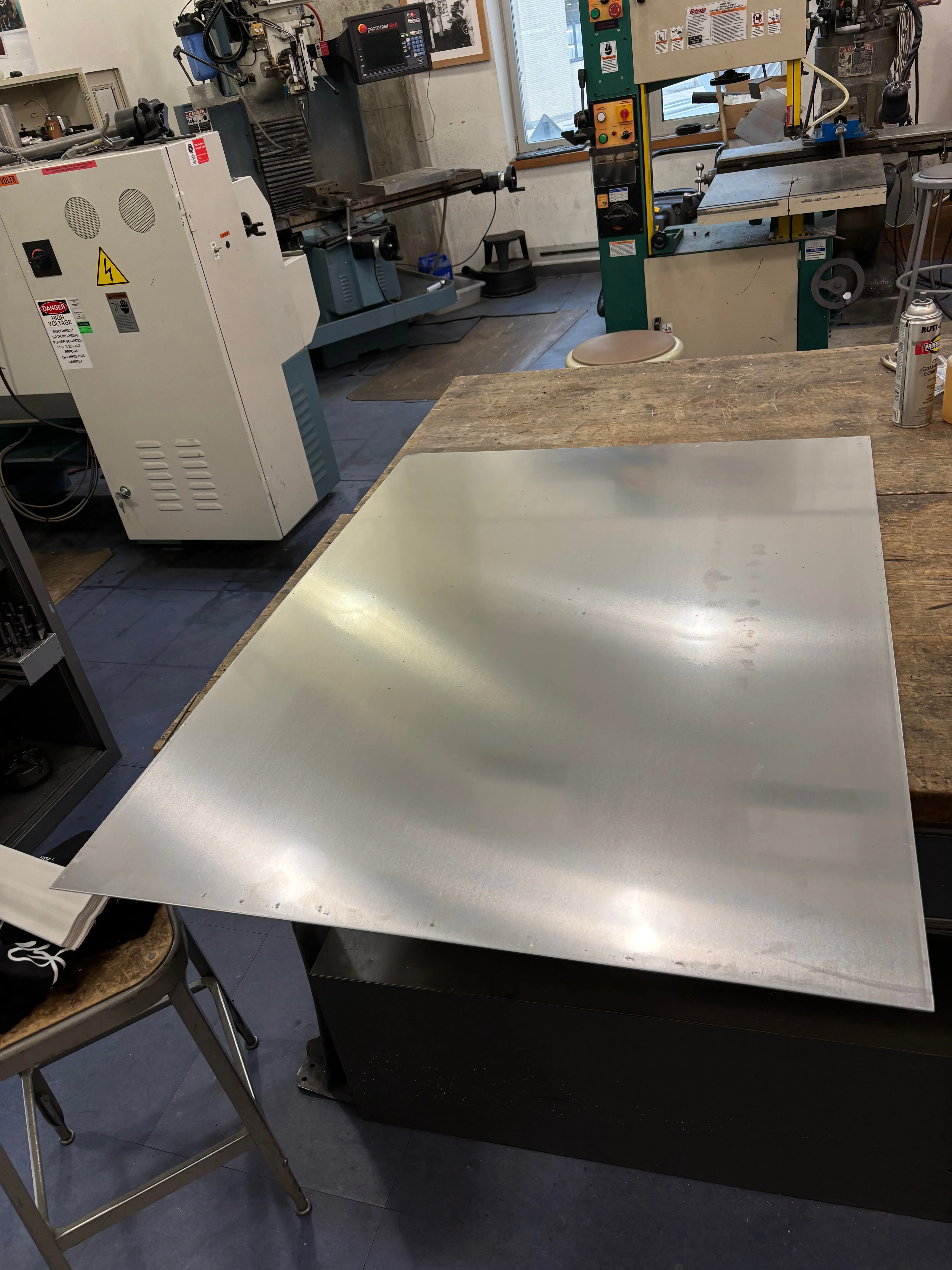 Large sheet of aluminum on a work bench.