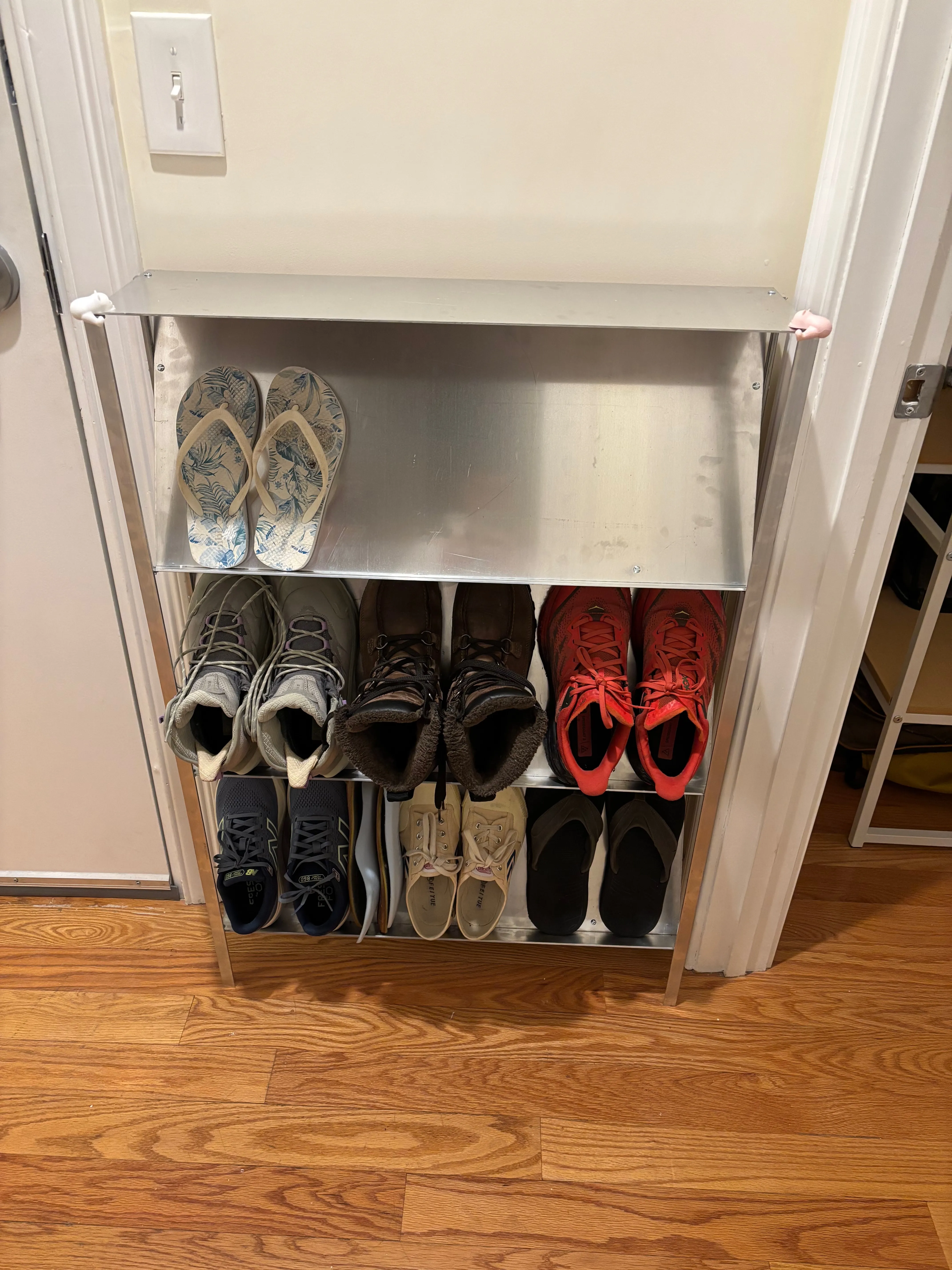 Front view of the shoe rack with our shoes on them