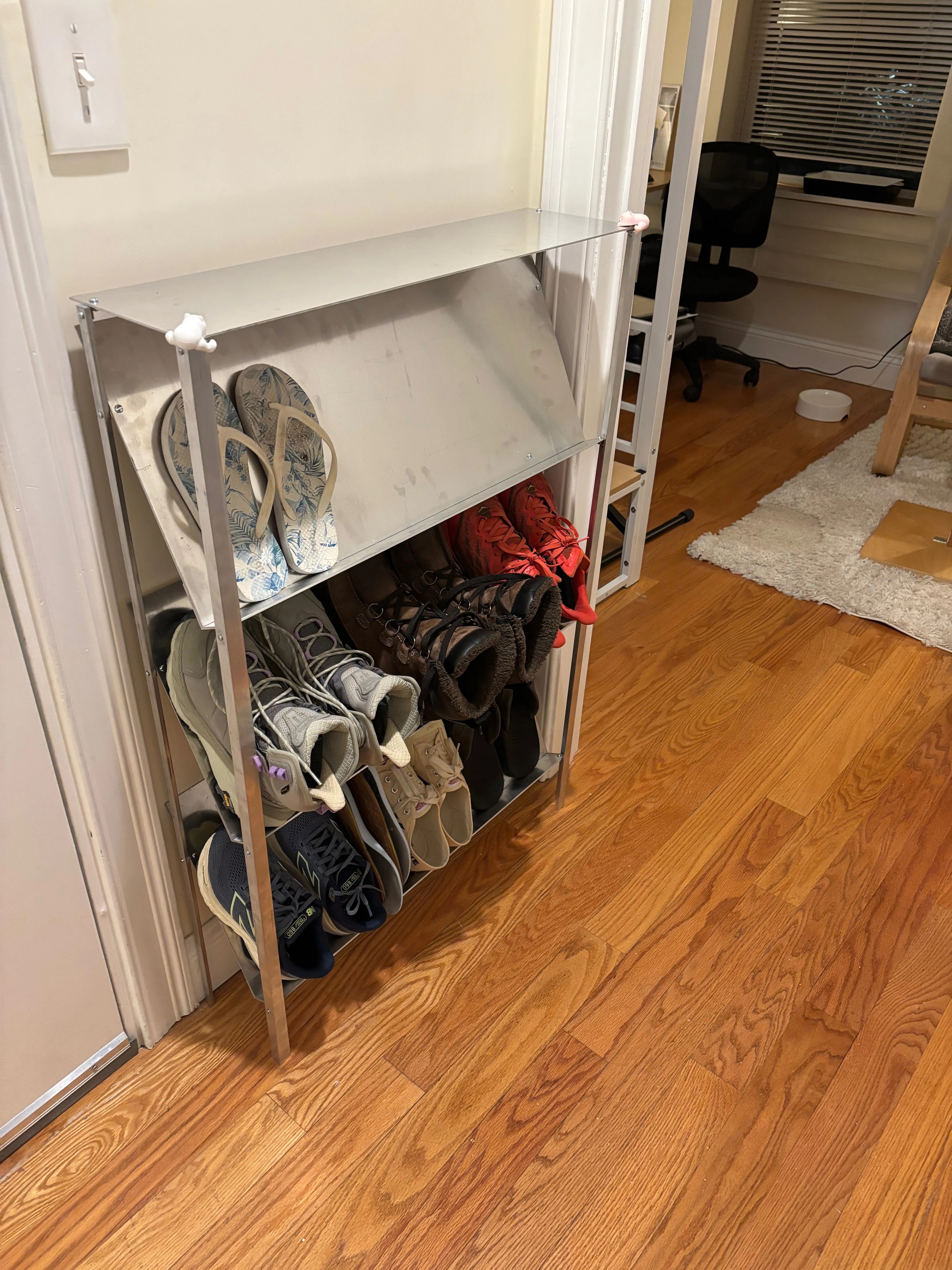 An aluminum shoe rack filled with shoes.