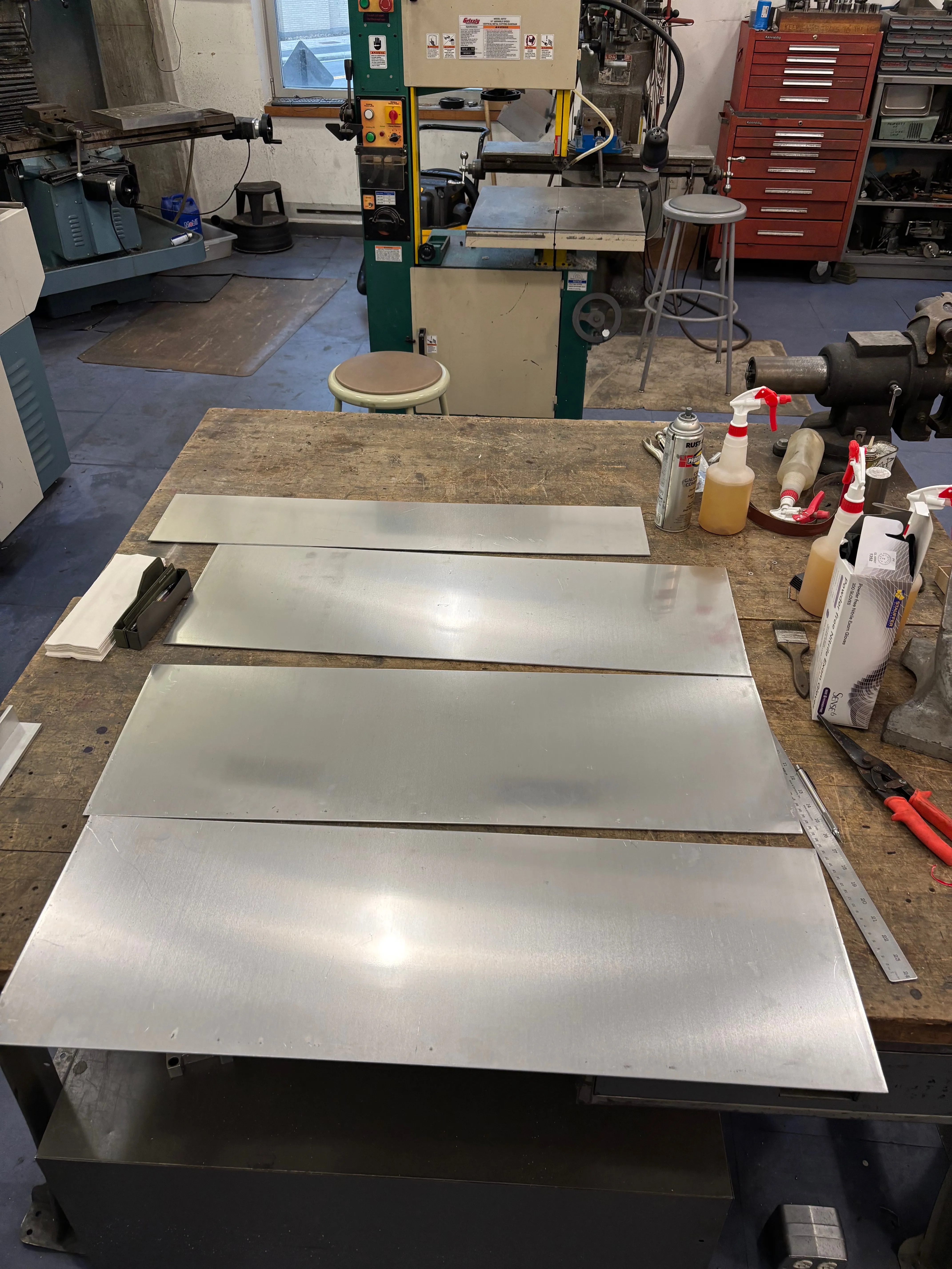 Smaller rectangular pieces of sheet metal on a workbench