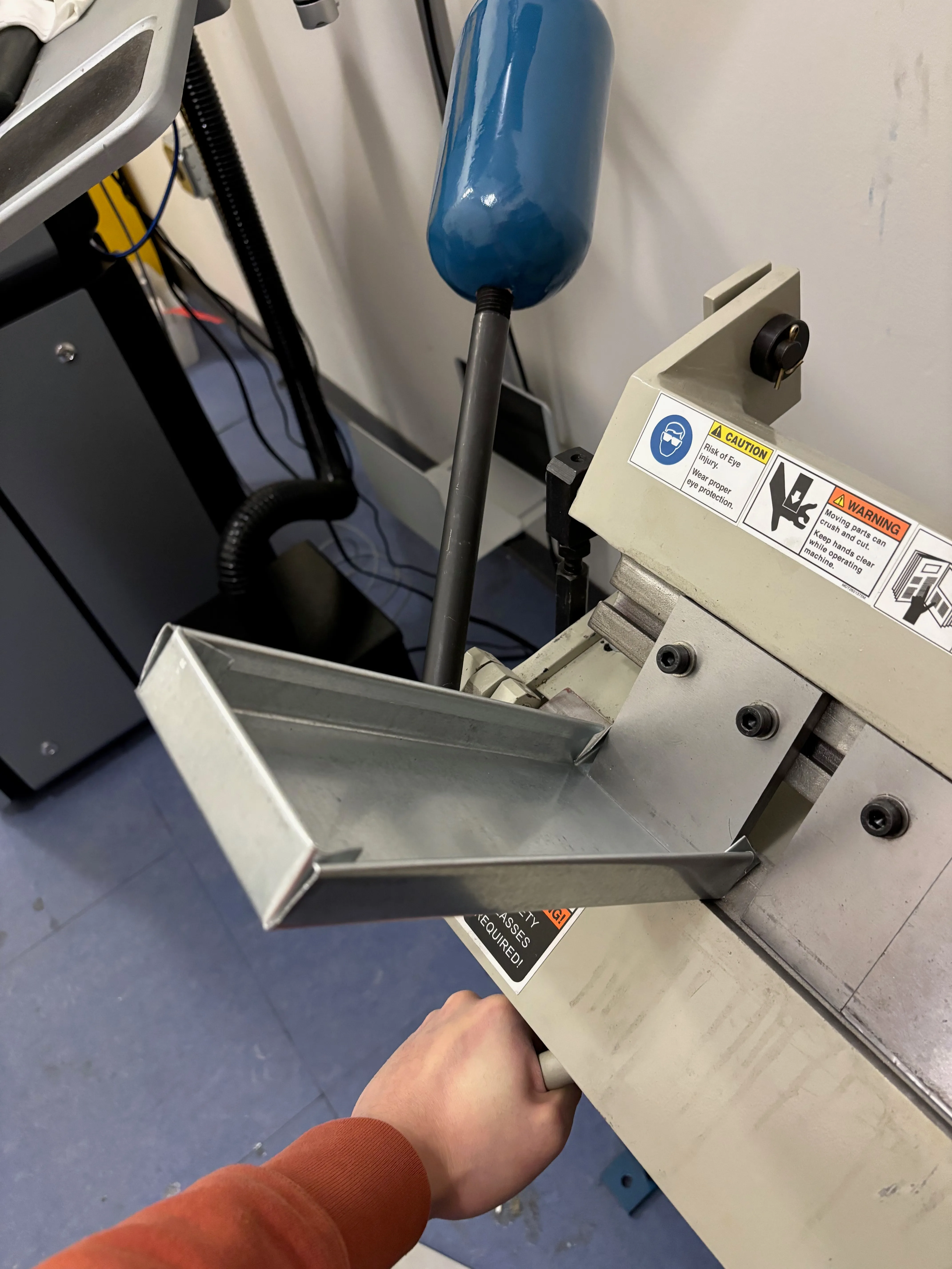 Partially bent sheet metal piece in sheet metal brake