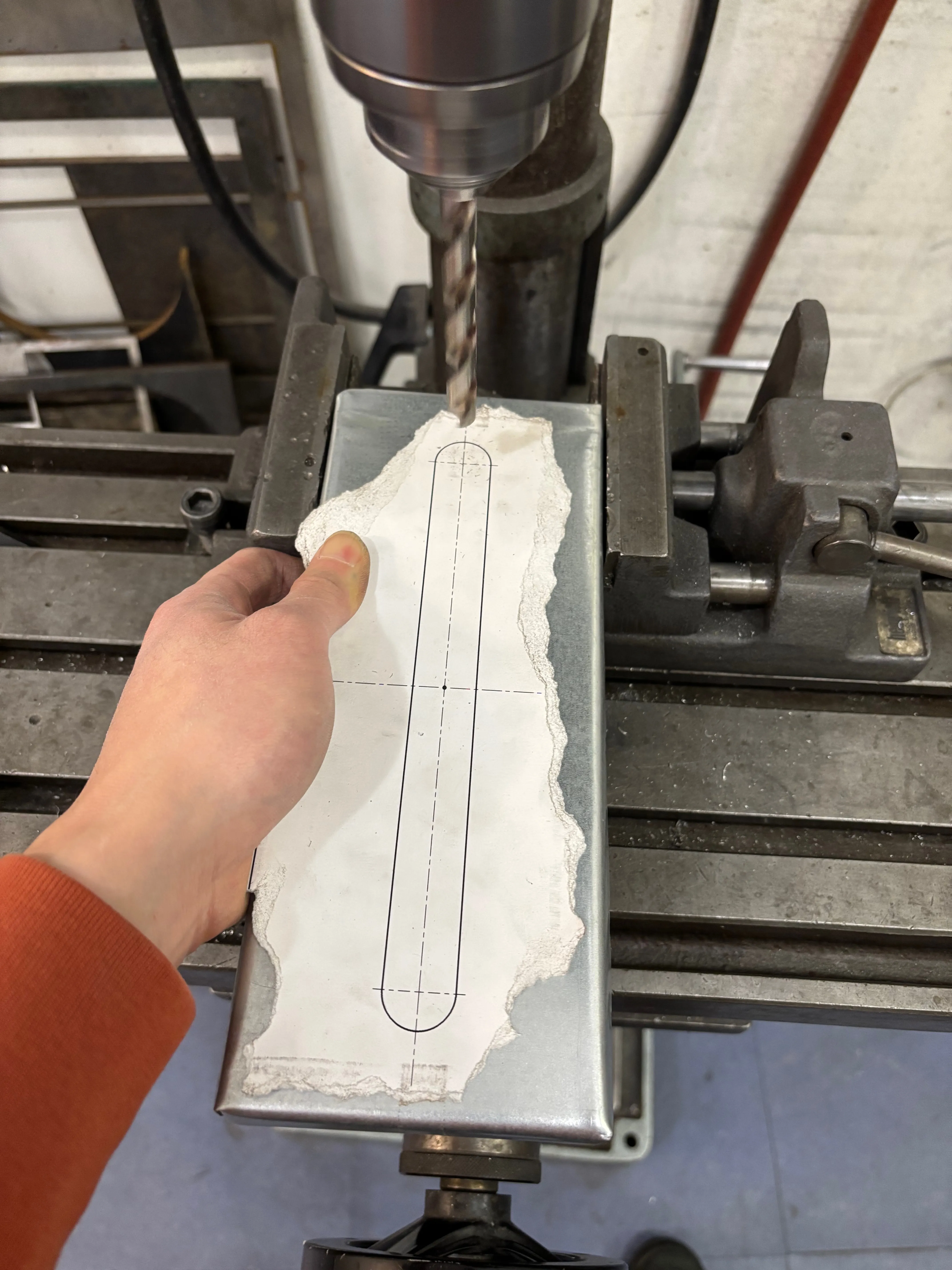 Top of sheet metal tissue box in a drill press