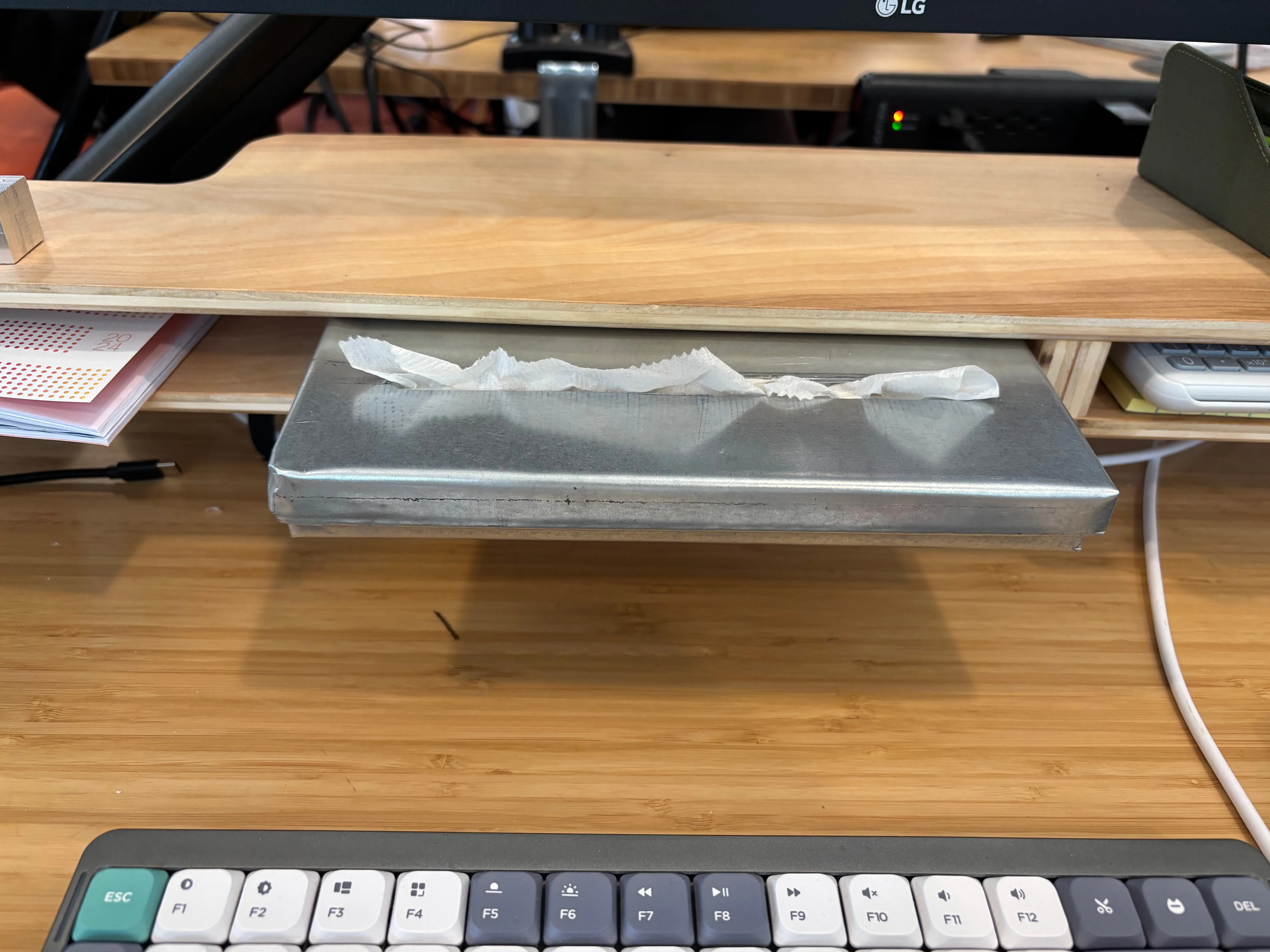 Tissue box cantilevered from shelf opening