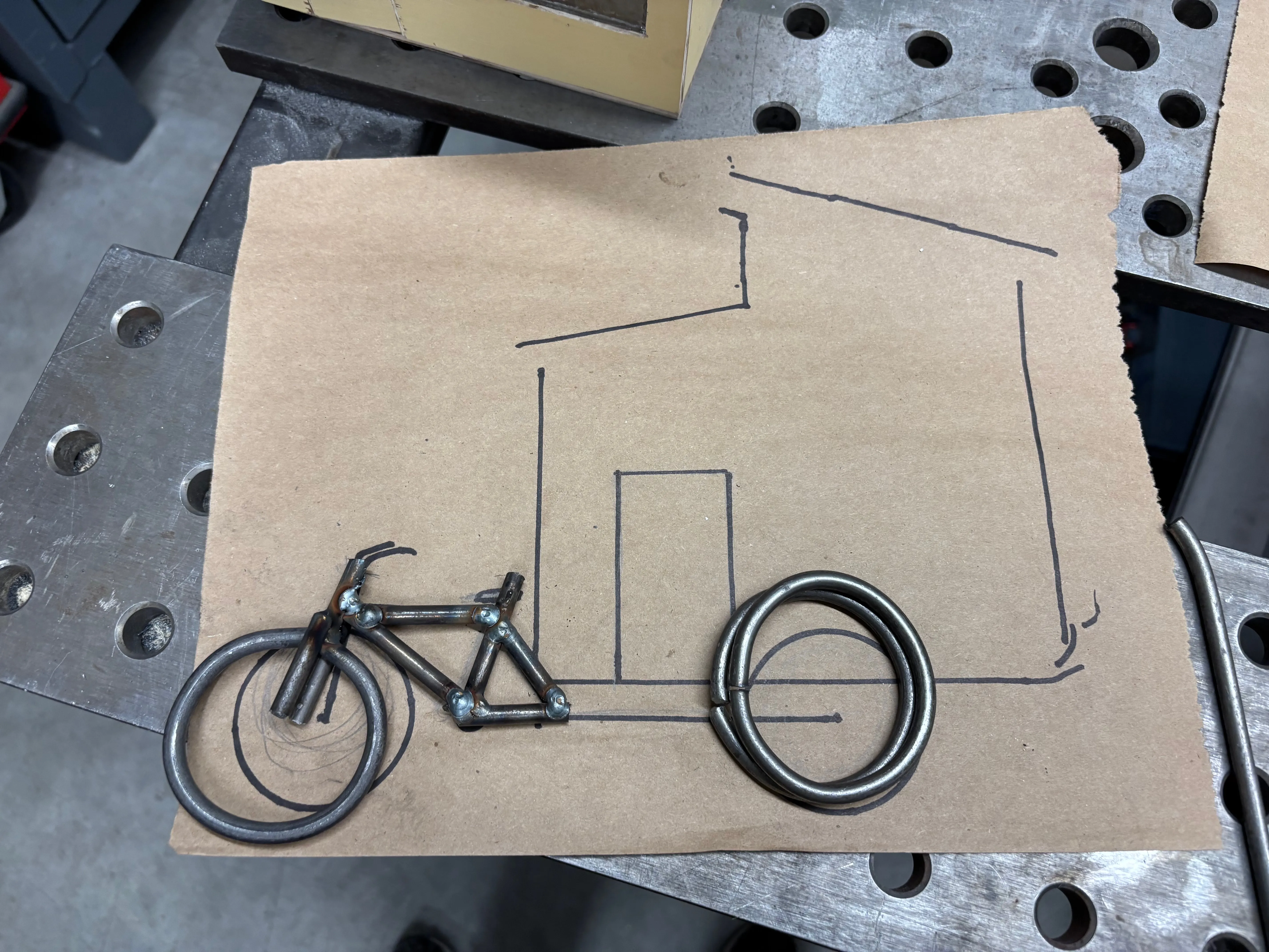 Bike frame and wheels placed on the sketch