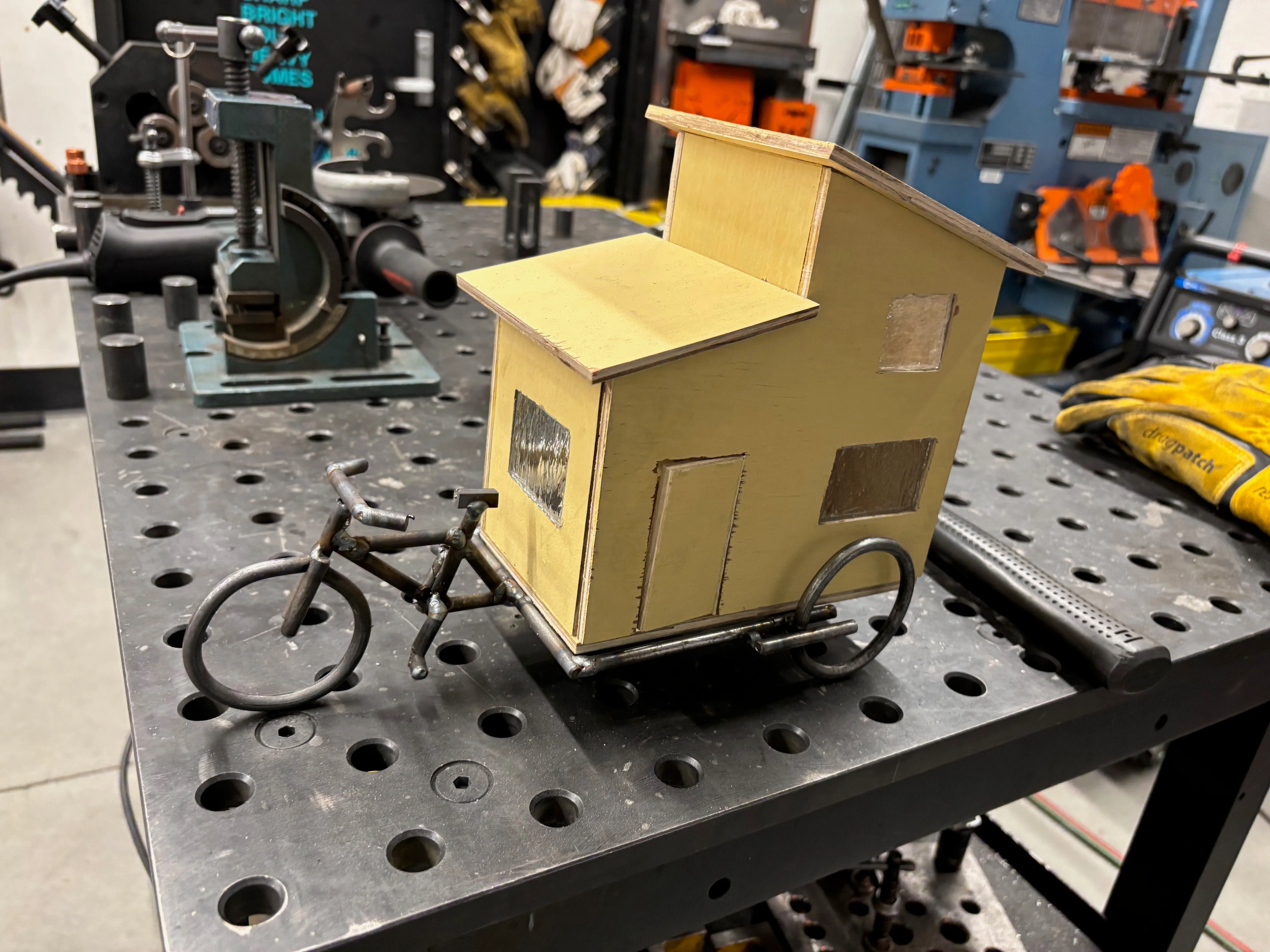 Completed bike frame with house on top.