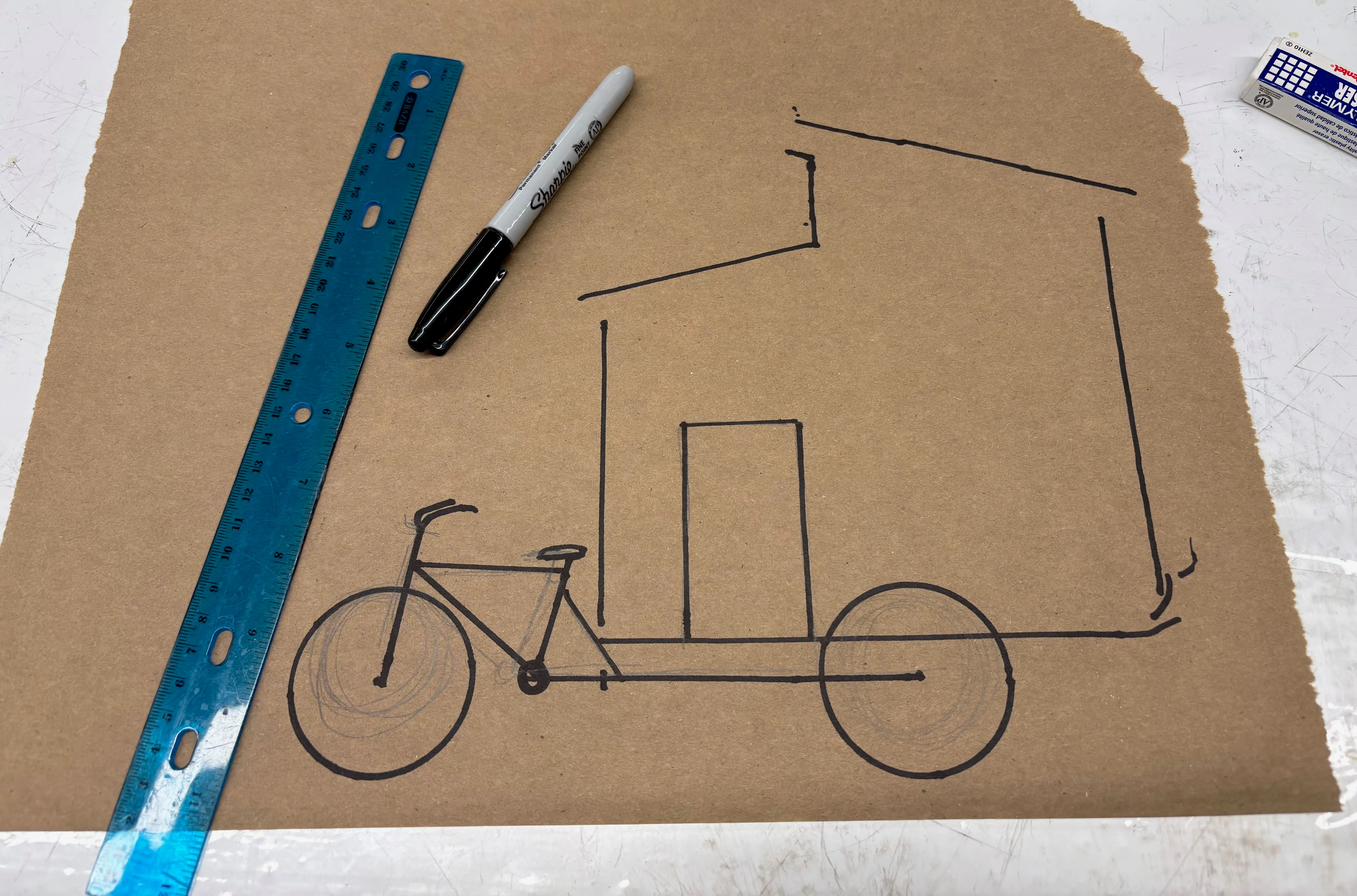 Sketch of house and bike in marker.